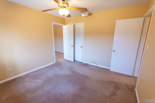 unfurnished bedroom with carpet, baseboards, ceiling fan, and a closet