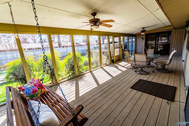 sunroom with a ceiling fan and a wealth of natural light