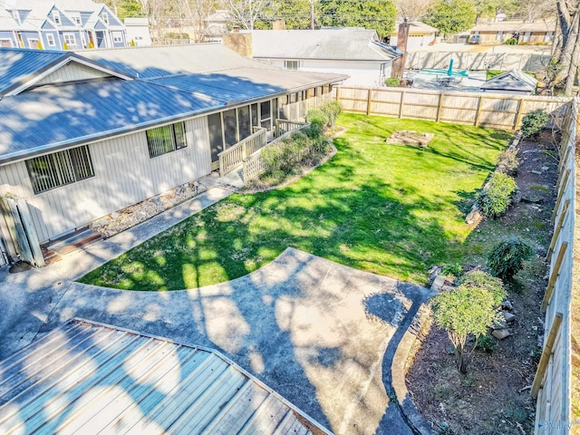 exterior space featuring a sunroom, a fenced backyard, and a patio area