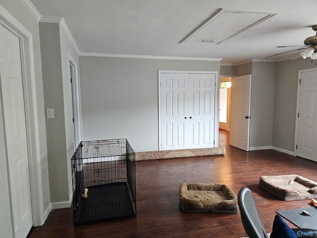 interior space with ceiling fan, crown molding, and dark hardwood / wood-style floors