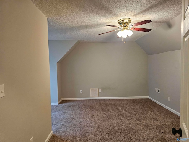 bonus room featuring carpet, vaulted ceiling, a textured ceiling, and ceiling fan