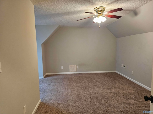 additional living space with ceiling fan, carpet flooring, and a textured ceiling