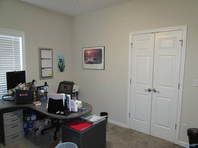 carpeted office featuring baseboards