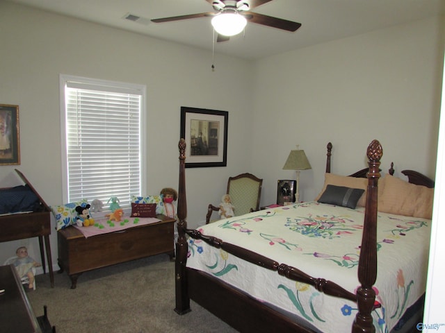 bedroom with carpet floors, visible vents, and ceiling fan