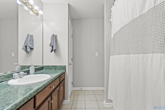 bathroom featuring vanity, baseboards, and tile patterned floors