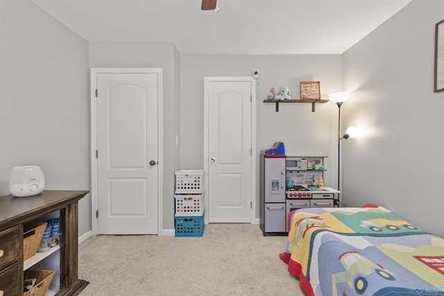 bedroom with a ceiling fan, carpet flooring, and baseboards