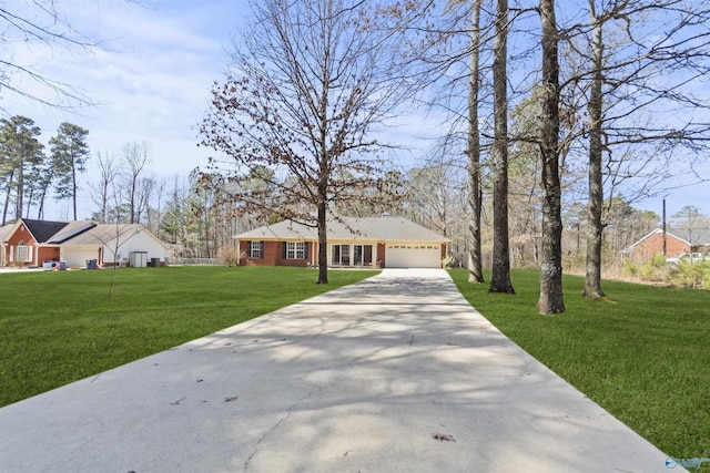 view of front facade featuring an attached garage, a front lawn, and concrete driveway