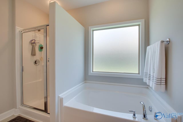 bathroom with a garden tub and a shower stall