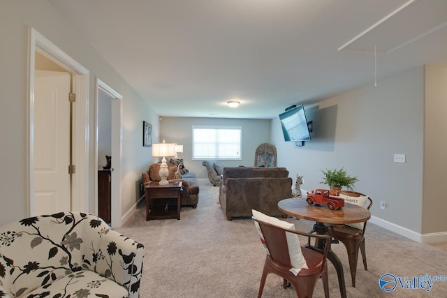 living room featuring light carpet, attic access, and baseboards