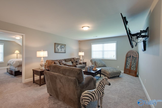 living room featuring baseboards and light colored carpet