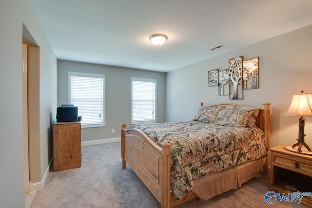 bedroom featuring carpet flooring, visible vents, and baseboards