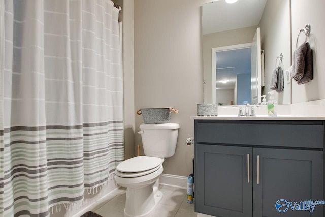 bathroom featuring a shower with shower curtain, toilet, vanity, tile patterned flooring, and baseboards