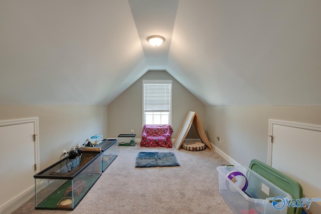 playroom featuring carpet floors, baseboards, and vaulted ceiling