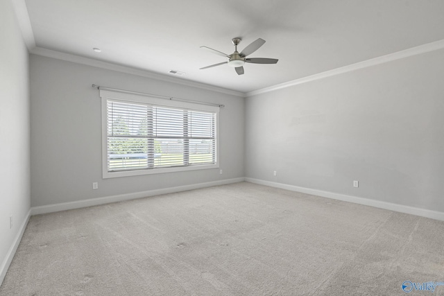 carpeted empty room with ceiling fan and crown molding