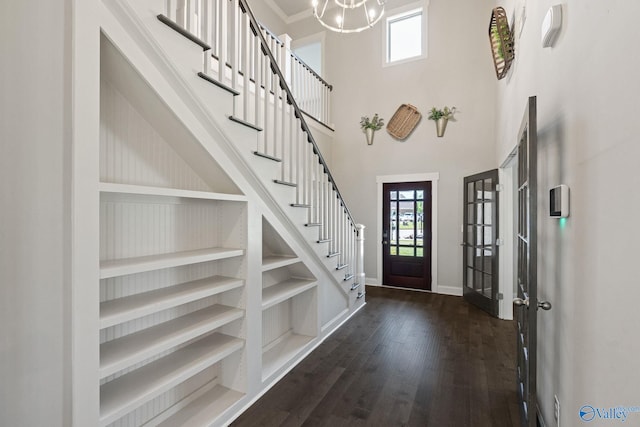 entryway featuring dark hardwood / wood-style floors, a high ceiling, and a notable chandelier