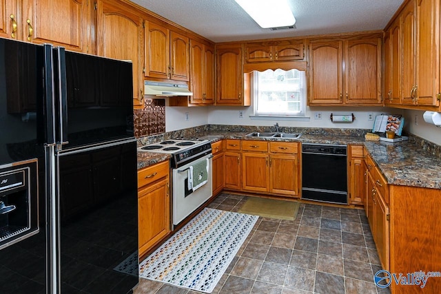 kitchen with sink, black appliances, dark stone counters, and a textured ceiling