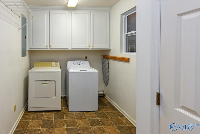 laundry room with cabinets, electric panel, and washer and clothes dryer