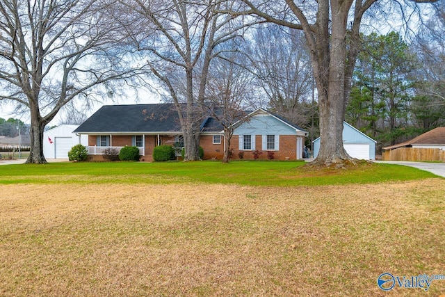 ranch-style house with an outbuilding, a garage, and a front yard