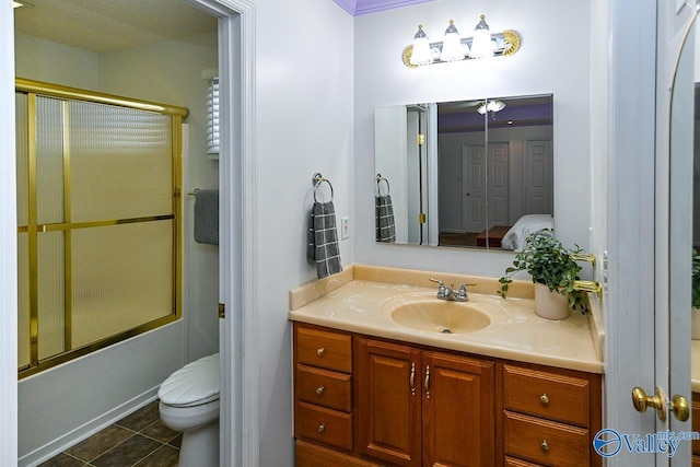full bathroom featuring tile patterned flooring, vanity, shower / bath combination with glass door, and toilet
