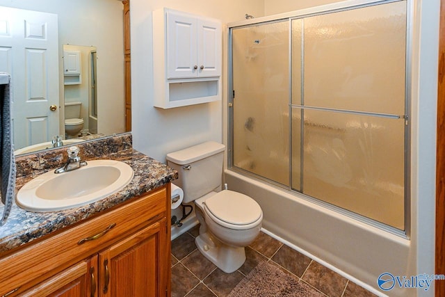 full bathroom with vanity, tile patterned flooring, enclosed tub / shower combo, and toilet