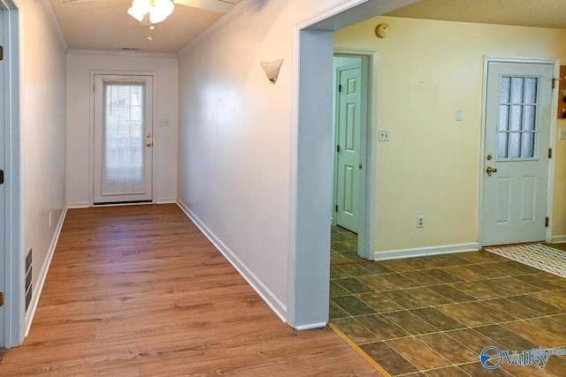 foyer with crown molding, dark hardwood / wood-style floors, and ceiling fan