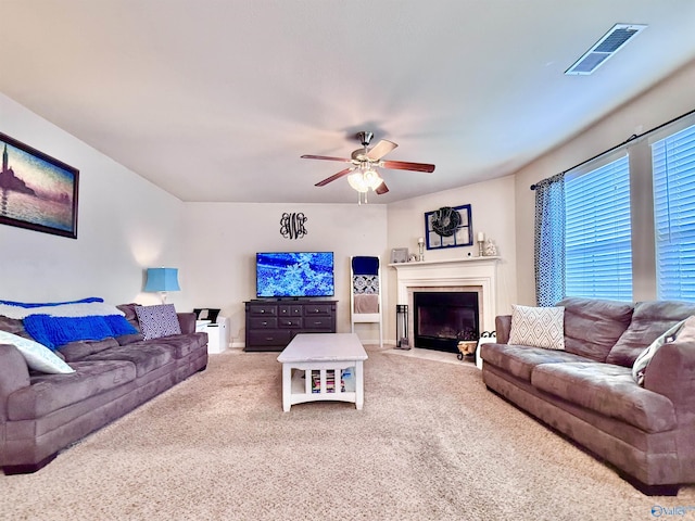 carpeted living room featuring ceiling fan