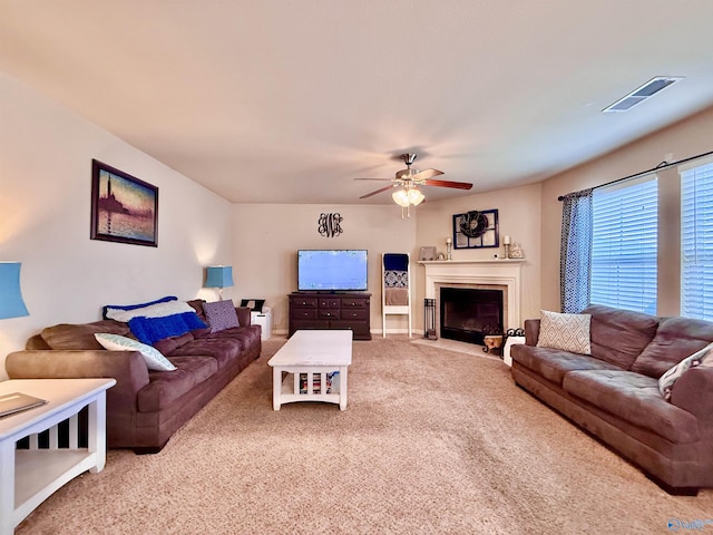 living room with ceiling fan and carpet floors