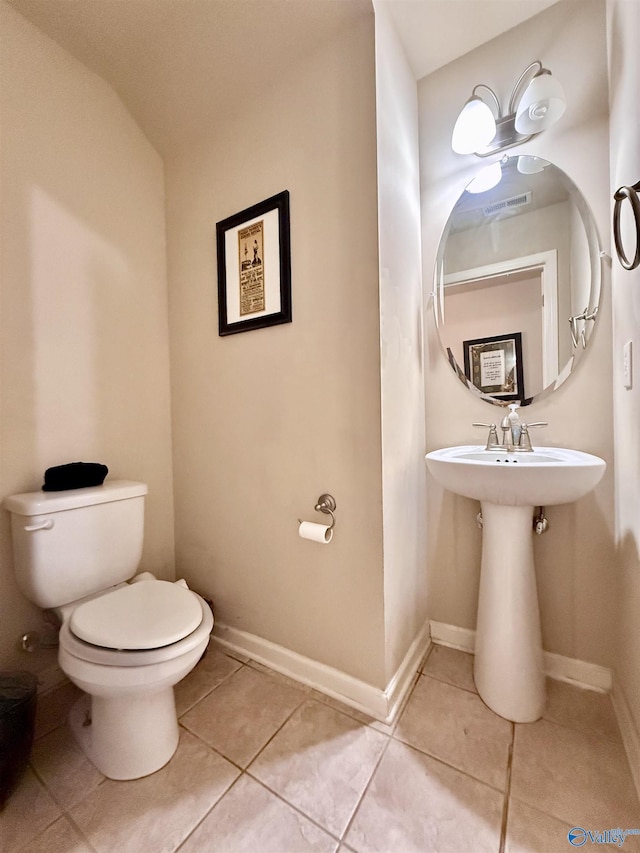 bathroom featuring tile patterned floors and toilet