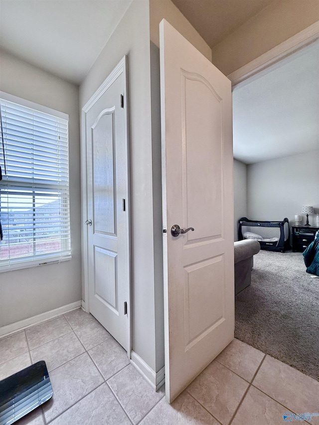 hallway with light tile patterned floors