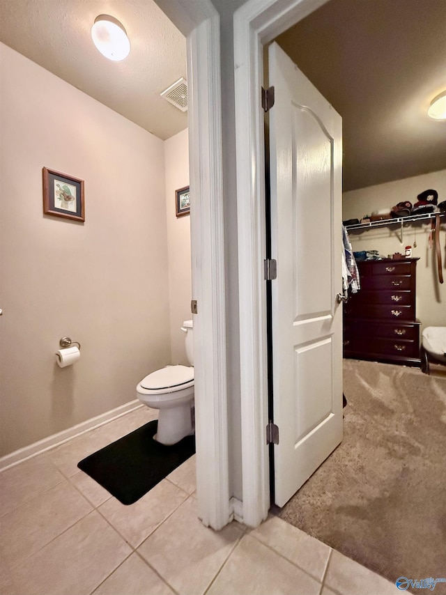 bathroom featuring tile patterned floors and toilet