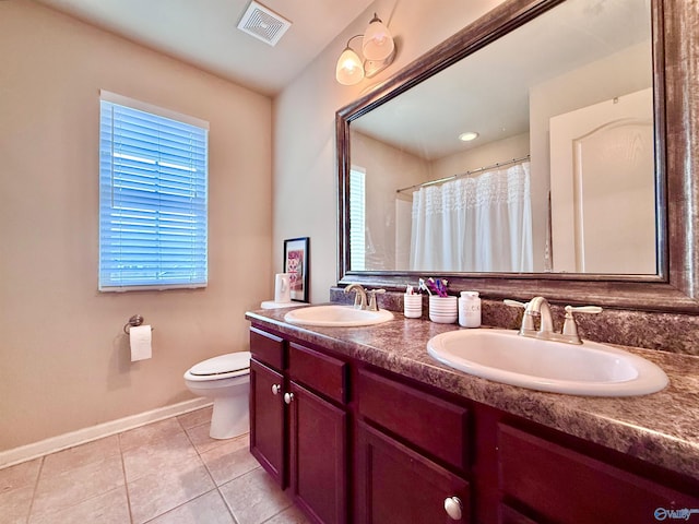 bathroom with tile patterned flooring, vanity, a shower with curtain, and toilet