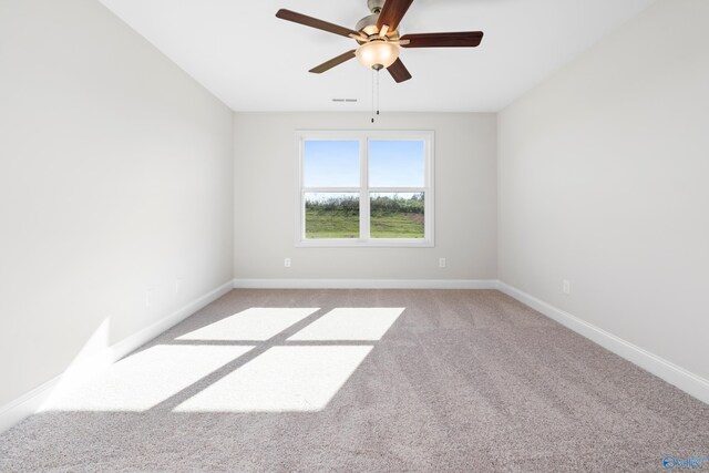 carpeted spare room featuring ceiling fan