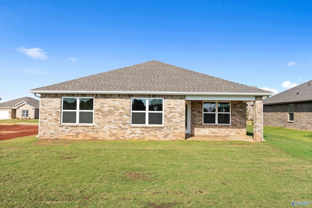 rear view of house with a yard