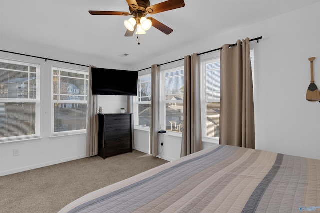 unfurnished bedroom featuring visible vents, baseboards, ceiling fan, and carpet flooring