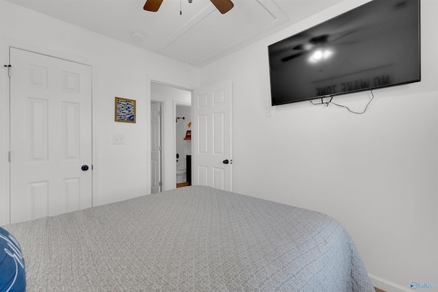 bedroom featuring attic access and ceiling fan