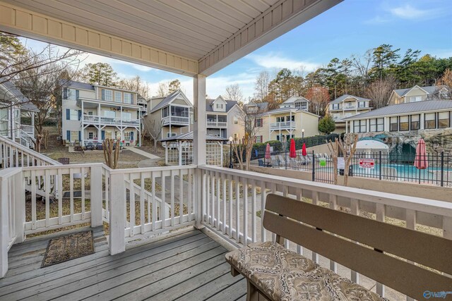 deck with a residential view and fence