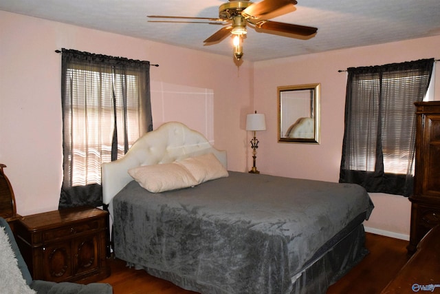 bedroom with a ceiling fan and wood finished floors