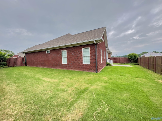 rear view of house with a lawn