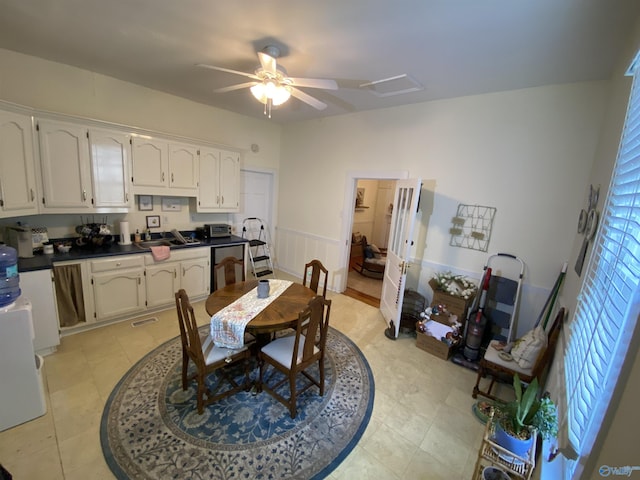 702 Mckinley Ave, Huntsville, AL 35801 - dining area featuring a ceiling fan and a wainscoted wall