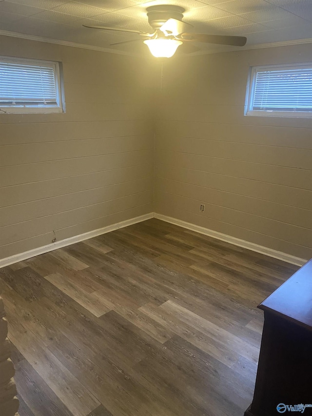 702 Mckinley Ave, Huntsville, AL 35801 - empty room with dark wood-style floors, ceiling fan, healthy amount of natural light, ornamental molding, and baseboards
