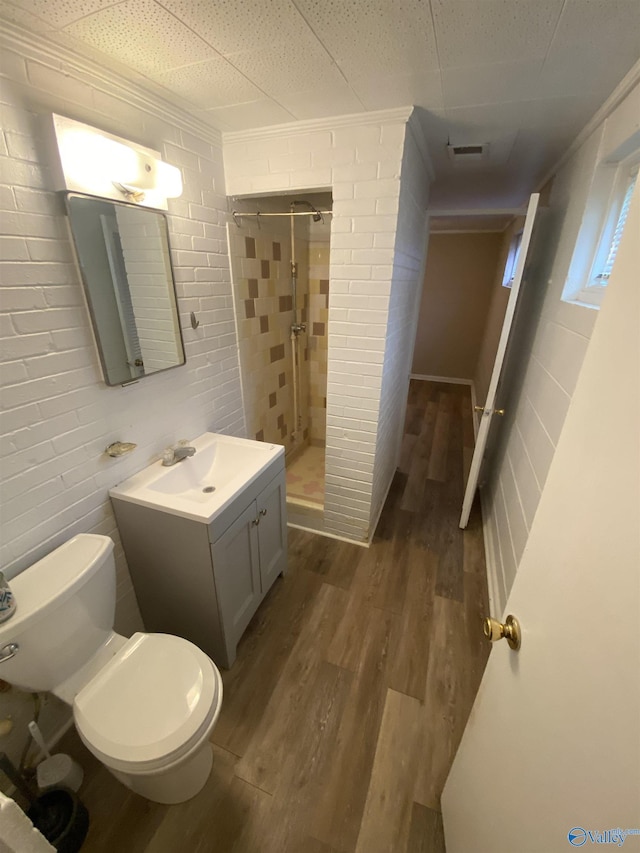 702 Mckinley Ave, Huntsville, AL 35801 - full bath featuring a stall shower, wood finished floors, vanity, toilet, and ornamental molding