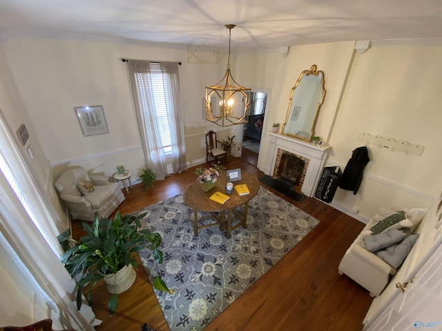 702 Mckinley Ave, Huntsville, AL 35801 - living area featuring a chandelier, wood finished floors, a fireplace, and crown molding