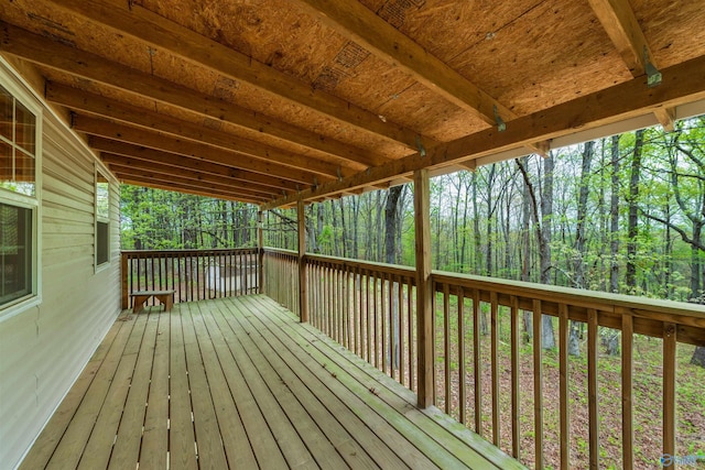 wooden deck featuring a forest view