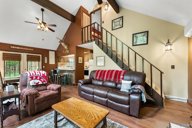 living area featuring french doors, stairway, ceiling fan, wood finished floors, and beamed ceiling