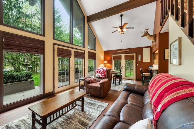 living area featuring a healthy amount of sunlight, wood finished floors, and french doors