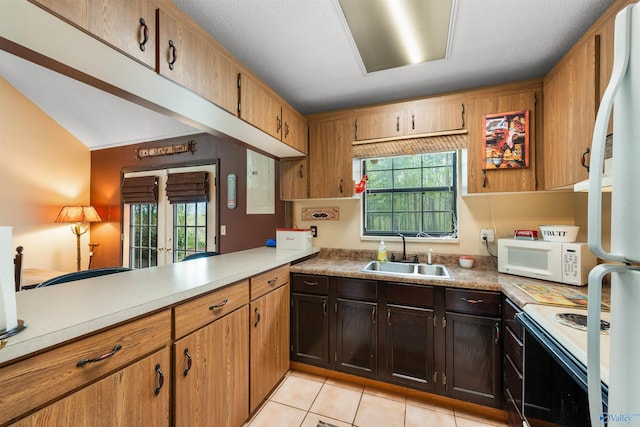 kitchen with white appliances, light countertops, and a sink