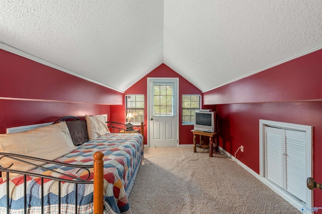 carpeted bedroom featuring lofted ceiling, a textured ceiling, and baseboards