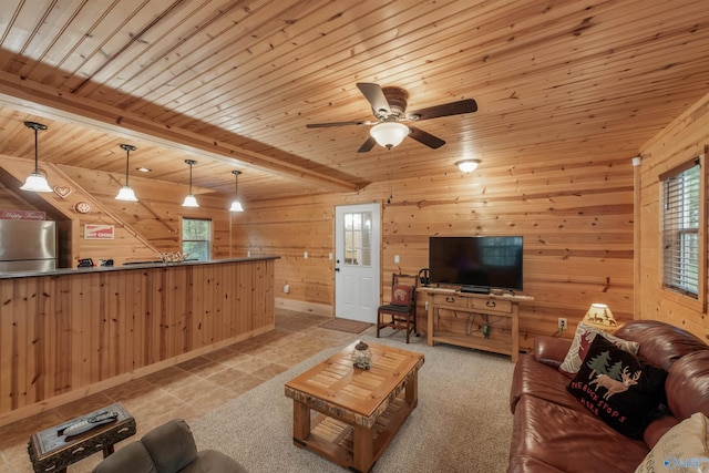 living room with beam ceiling, wooden ceiling, plenty of natural light, and ceiling fan