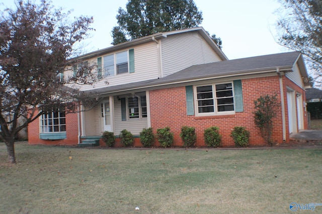 front facade with a front lawn and a garage