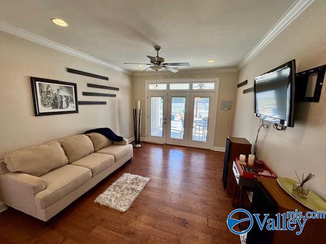 living room with ceiling fan, ornamental molding, and dark hardwood / wood-style flooring